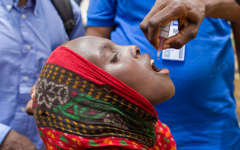 Child receiving oral polio vaccine